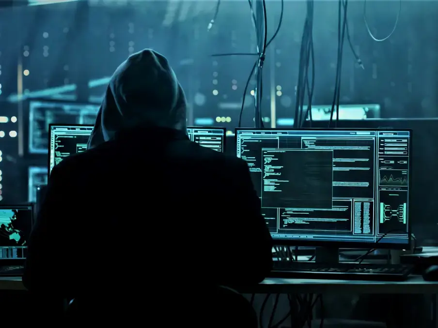 man and computer screens